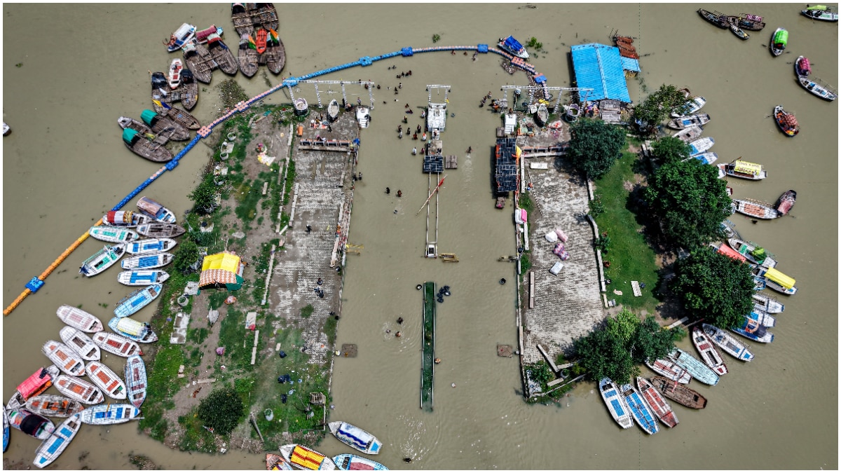 An aerial view shows boats anchored beside submerged floating pontoon jetties at Sangam as the water levels of the Ganga and Yamuna rivers swell