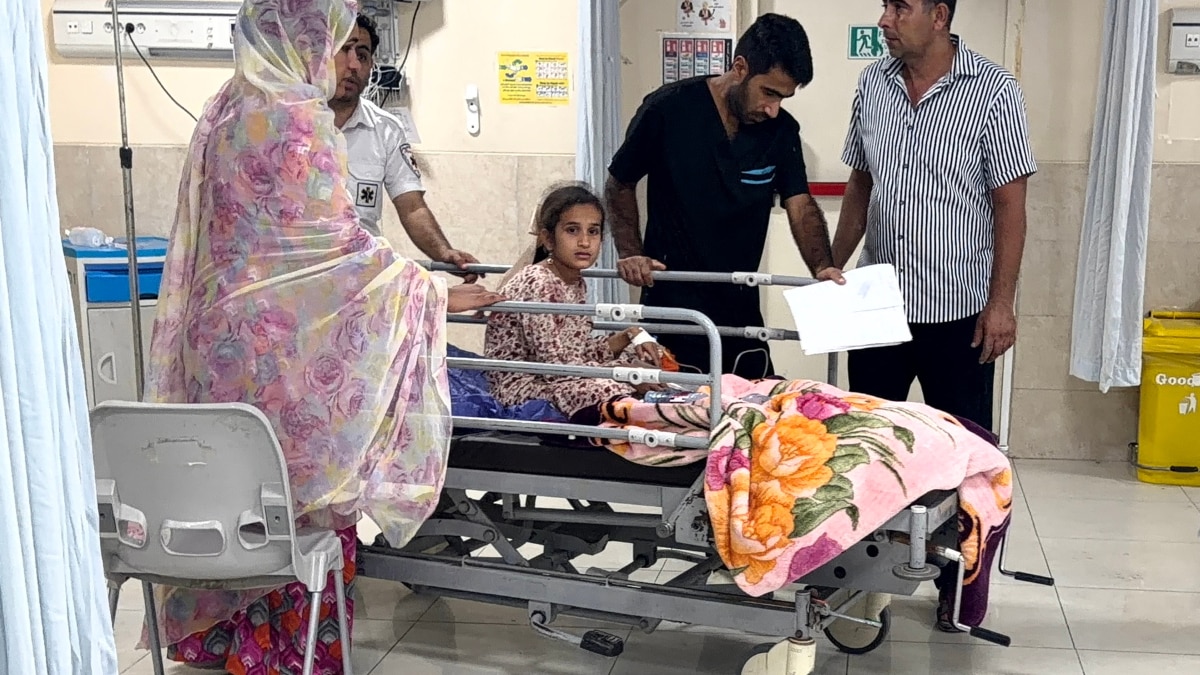 Wounded child lies on a hospital bed after airstrike in southern Iran