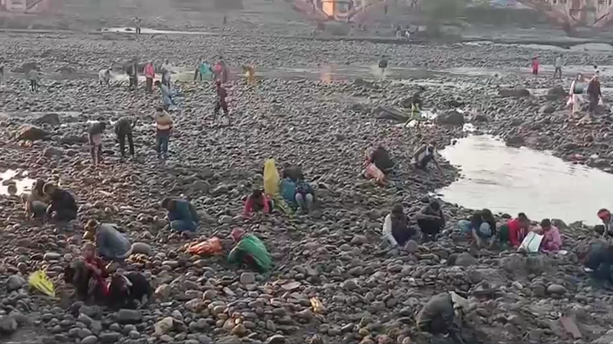 People searching coins in dry stream