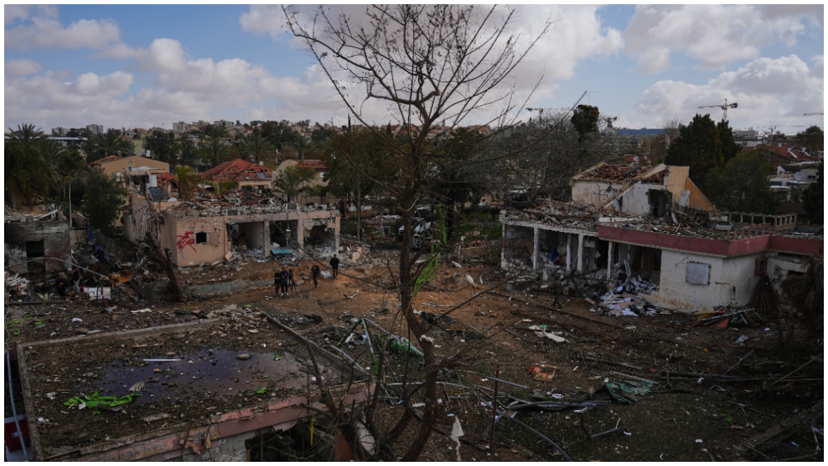 People survey a site that was struck by an Iranian missile in Dimona, southern Israel People survey a site that was struck by an Iranian missile in Dimona, southern Israel