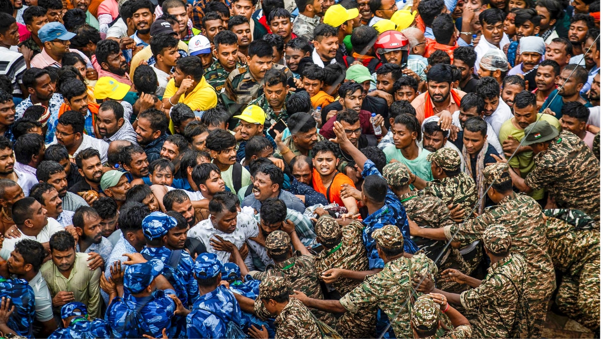 Security personnel manage the crowd during the annual 'Rath Yatra' festival, at the Jagannath Temple in Puri, Odisha