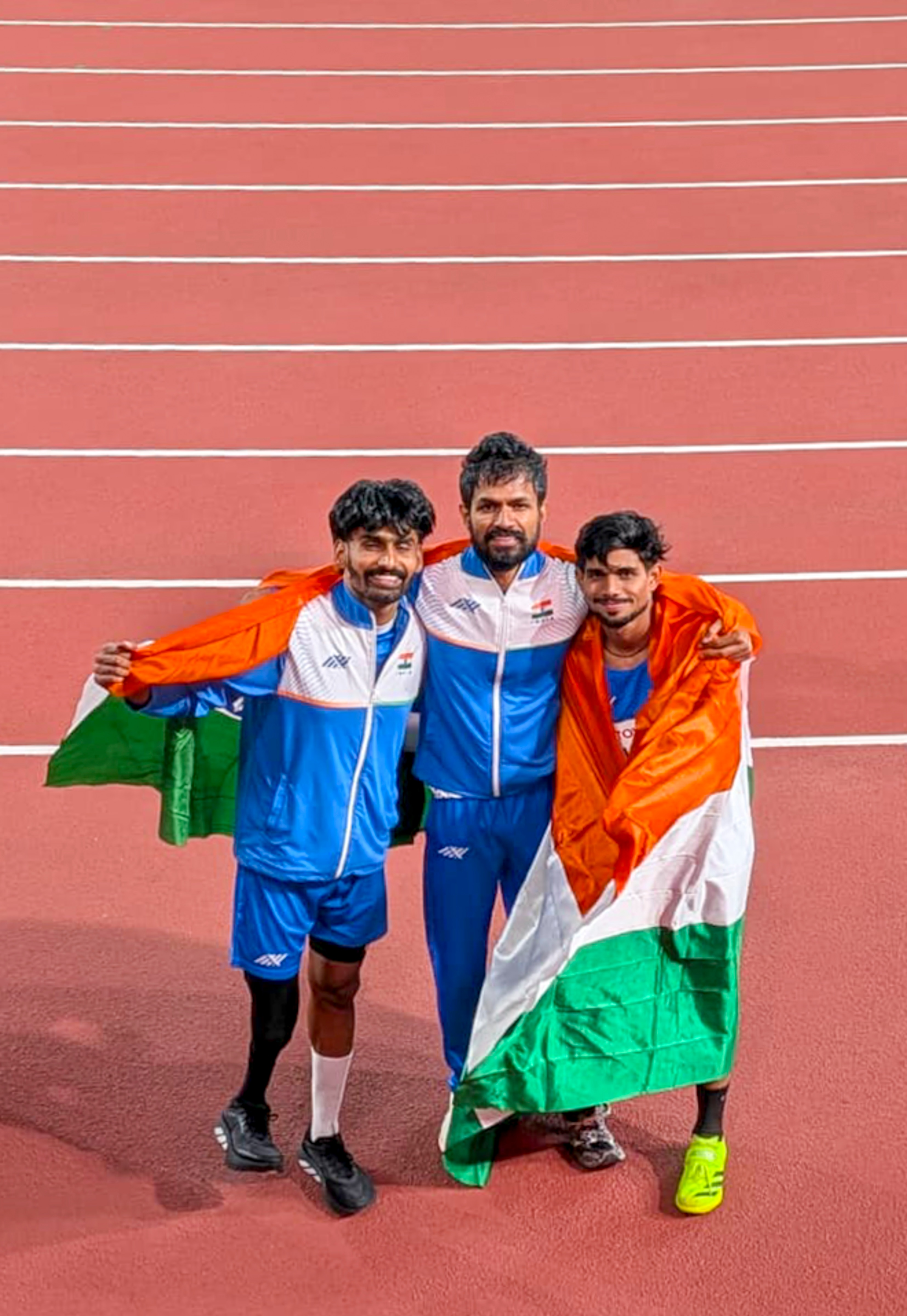 Shailesh Kumar, right, Varun Bhati, centre, and Rahul celebrate after winning gold, .jpg