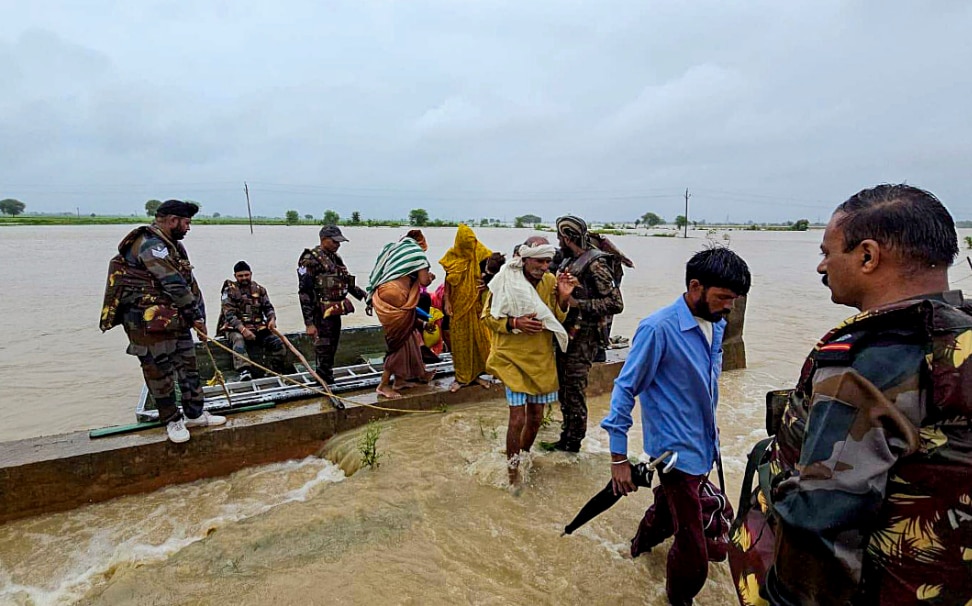 Army personnel rescue people from a flood-affected area, in Shivpuri district, Madhya Pradesh (PTI Photo)