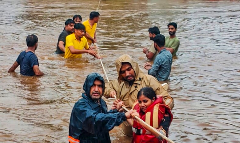 SDRF personnel evacuate people from a flood-affected area, in Sawai Madhopur district, Rajasthan (PTI Photo)