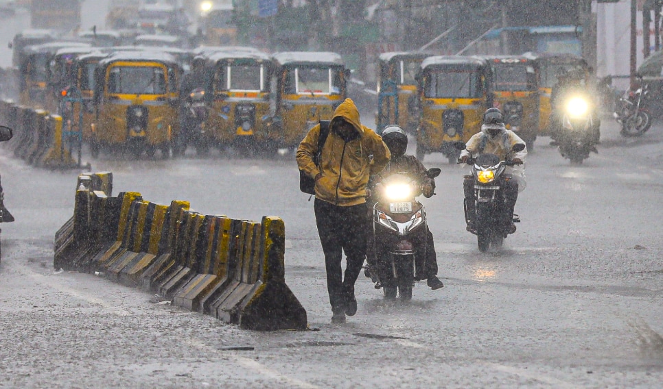 Commuters during rainfall in the Old City of Hyderabad (PTI Photo)