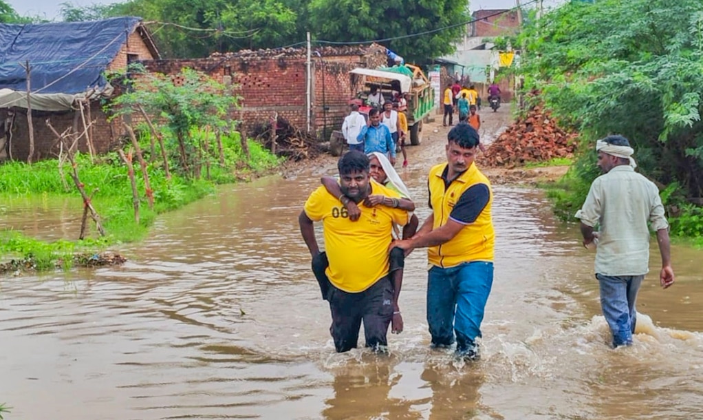 An elderly woman being evacuated from a flood-affected area in Dholpur district, Rajasthan (PTI Photo)