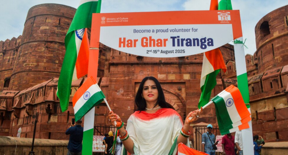  A visitor poses for pictures with the tricolour at Agra Fort. (PTI Photo)