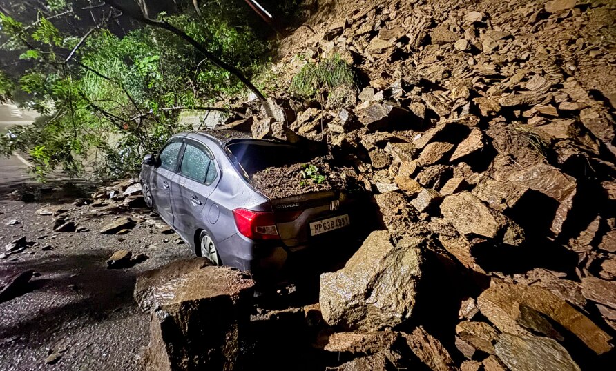 Wreckage of a car lies buried under debris and boulders after landslide due to heavy rainfall, in Shimla district, Himachal Pradesh, Sunday, Aug. 31, 2025. (PTI Photo)
