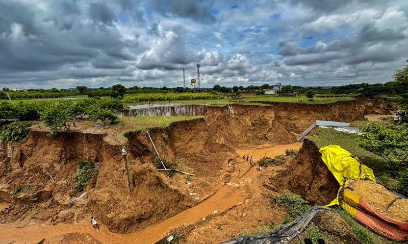 A deep crater formed due to the overflowing of the Surwal Dam, triggering land collapses and a flood-like situation following heavy rainfall, in Sawai Madhopur, Rajasthan (PTI Photo)
