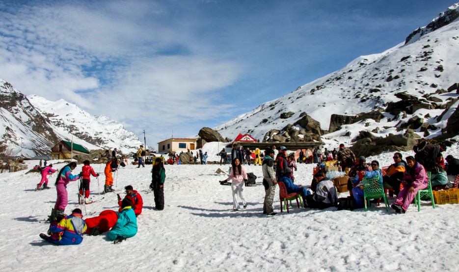Kullu: Tourists gather at a snow-covered area near the Atal Tunnel south portal, in Kullu district of Himachal Pradesh, (PTI Photo)