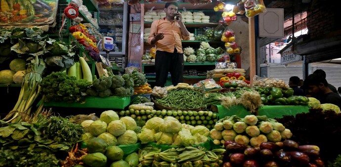 A vegetable vendor, speaks on his mobile phone at a retail market area in Kolkata. (Photo: Reuters) A vegetable vendor, speaks on his mobile phone at a retail market area in Kolkata. (Photo: Reuters)