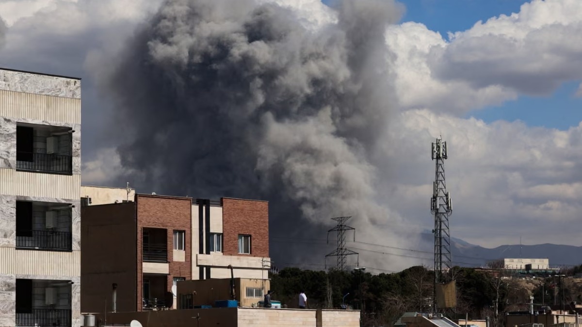 A plume of smoke rises following reported explosions in Tehran on 1 March 2026. (Photograph: Getty Images)