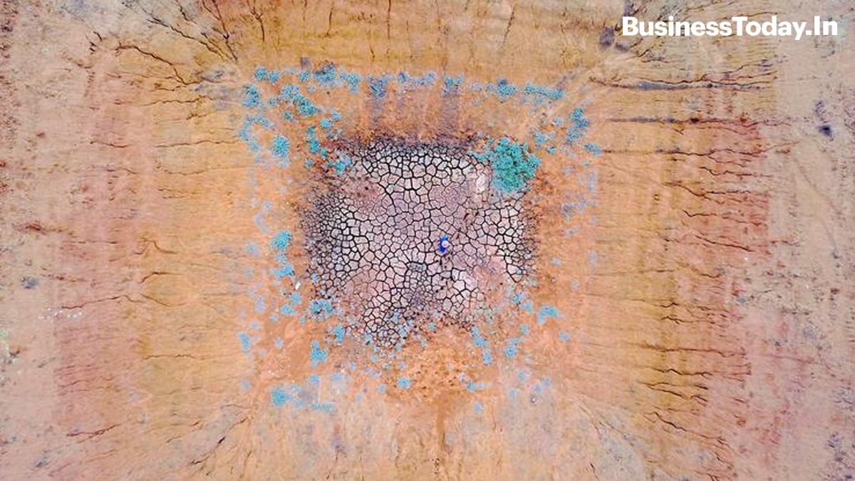 A farmer stands in the middle of a dried-up dam in a drought-effected paddock on his property located west of the town of Gunnedah in New South Wales, Australia.