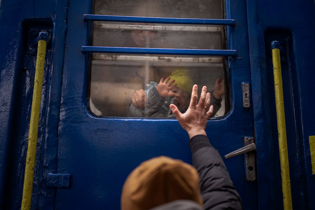 Stanislav says goodbye to his two-year-old son David and wife Anna after they boarded a train that will take them to Lviv, from the station in Kyiv, Ukraine. Stanislav stayed to fight as his family sought refuge in a neighboring country.