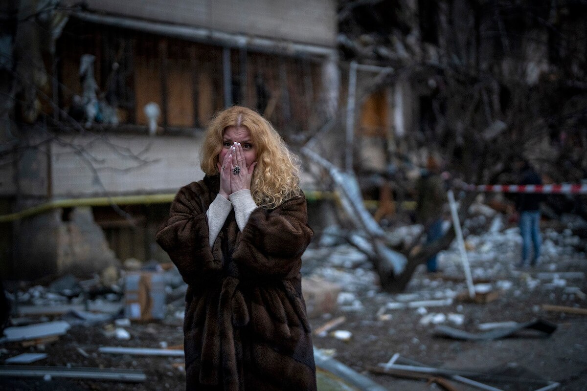 Natali Sevriukova stands near her house after a rocket attack in Kyiv, Ukraine.
