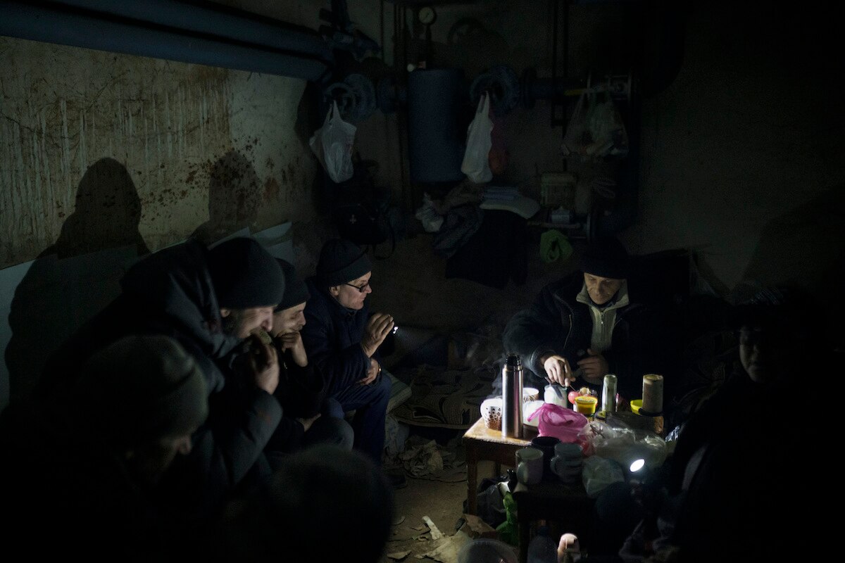 Residents prepare tea in a basement being used as a bomb shelter in Irpin, on the outskirts of Kyiv, Ukraine.