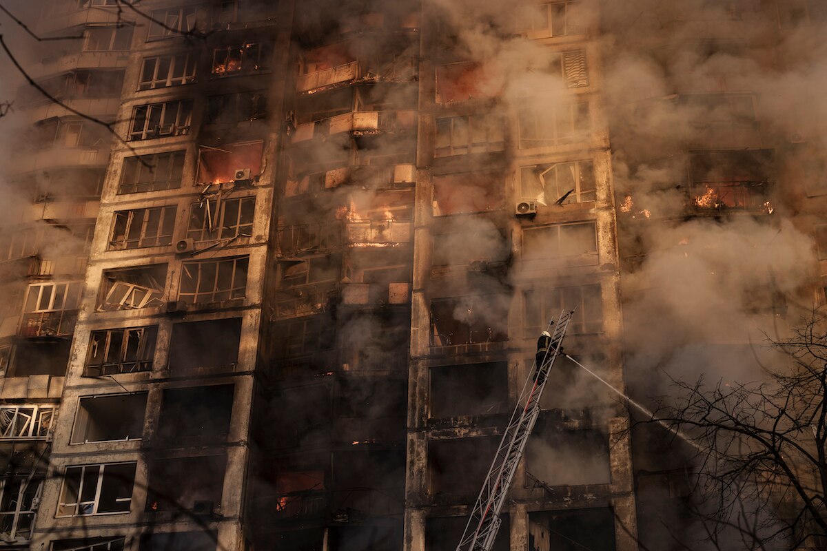 Ukrainian firefighters work at a bombed apartment building in Kyiv, Ukraine.