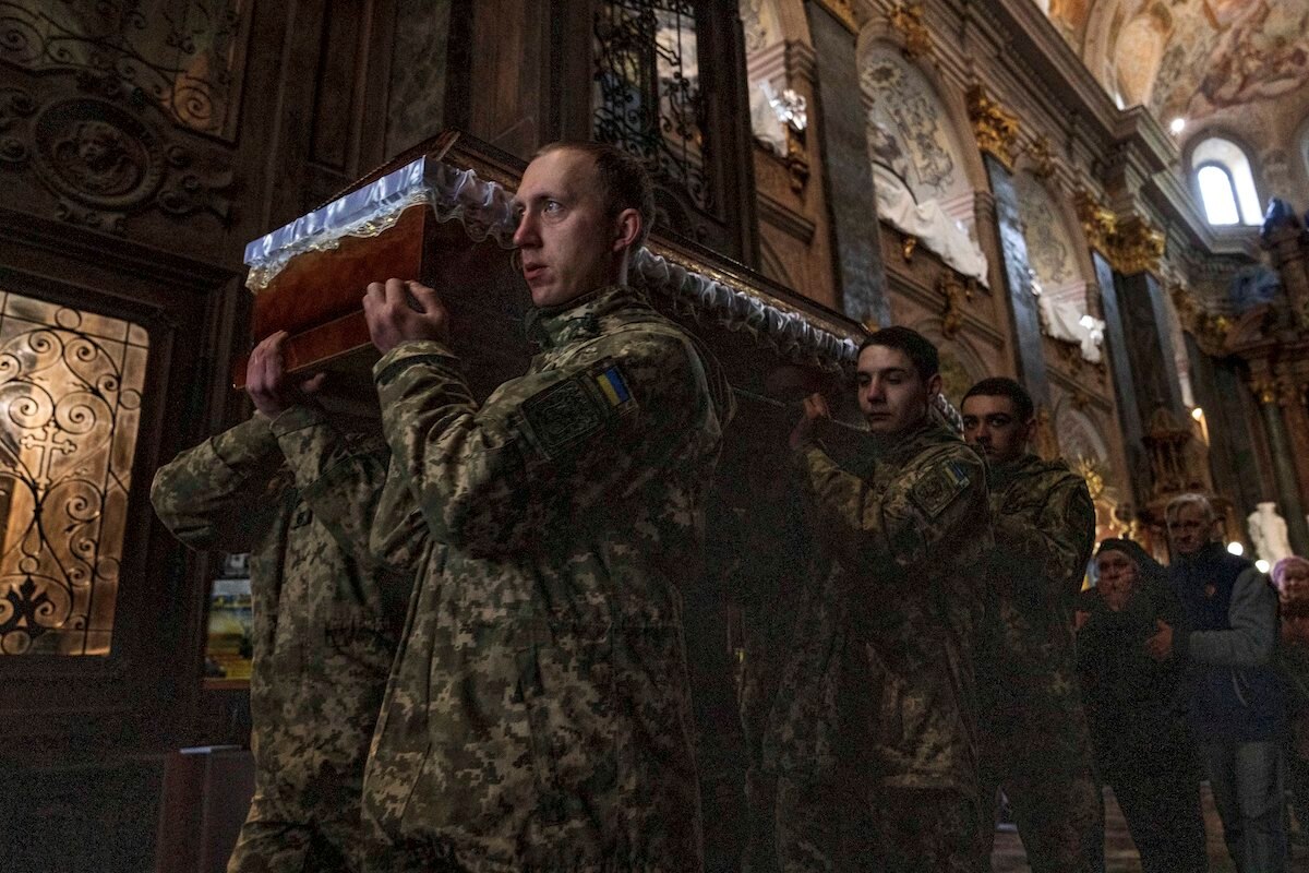 The mother of 40-year-old Senior Lieutenant Oliynyk Dmytro, who was killed in combat, mourns his death as she walks behind his coffin during his funeral outside the Holy Apostles Peter and Paul Church in Lviv, western Ukraine.