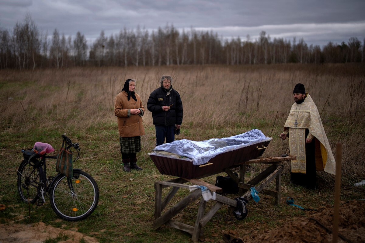 Nadiya Trubchaninova and her son Oleg Trubchaninov attend the funeral of her other son Vadym, who was killed by a Russian army gunshot on March 30, in Bucha on the outskirts of Kyiv, Ukraine.