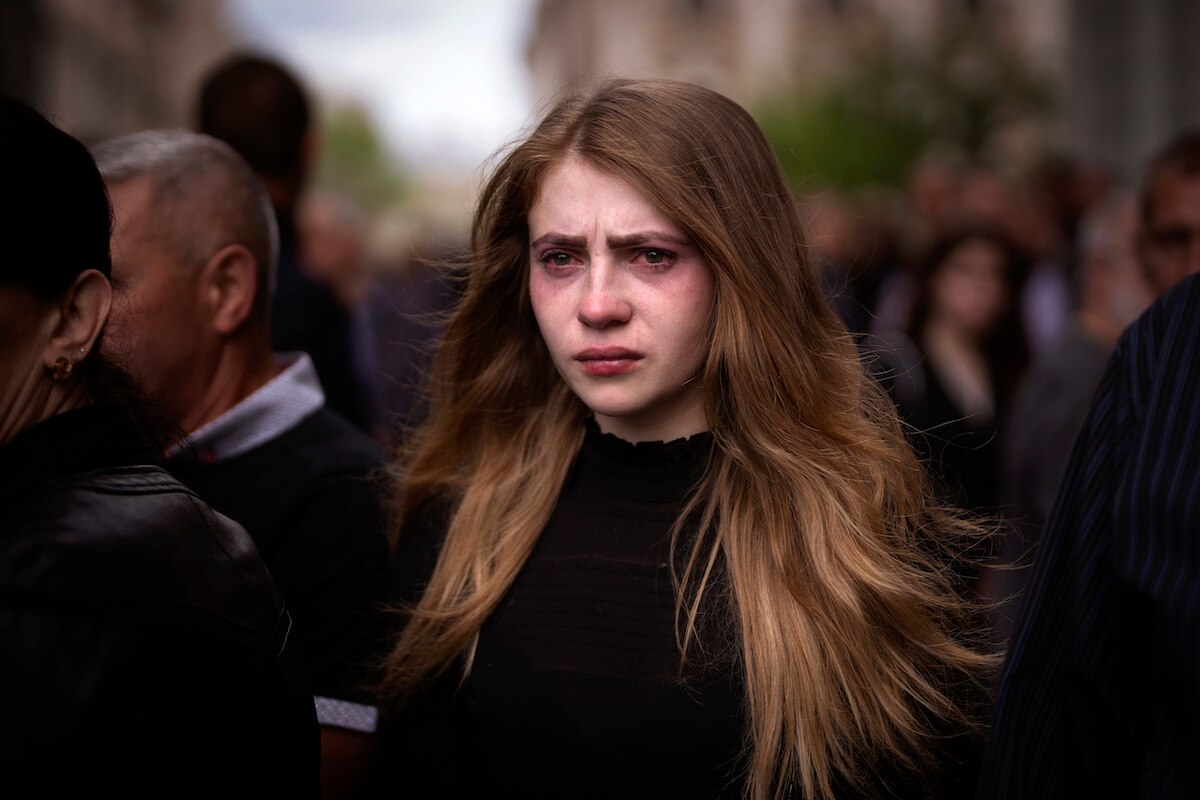 A woman cries during the funerals of three Ukrainian military servicemen, Melnyk Andriy, Shufryn Andriy and Ankratov Oleksandra, who were killed in the east of the country, in Lviv, Ukraine.
