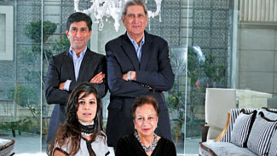 The Puris: (Left) Ratul with wife Kavita (sitting); Deepak and (sitting) wife Nita The Puris: (Left) Ratul with wife Kavita (sitting); Deepak and (sitting) wife Nita