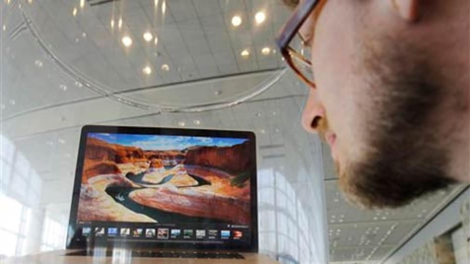 An attendee looks at the new MacBook Pro on display at the Apple Developers Conference in San Francisco on Monday, June 11, 2012.<em>Photo: AP</em> An attendee looks at the new MacBook Pro on display at the Apple Developers Conference in San Francisco on Monday, June 11, 2012.<em>Photo: AP</em>