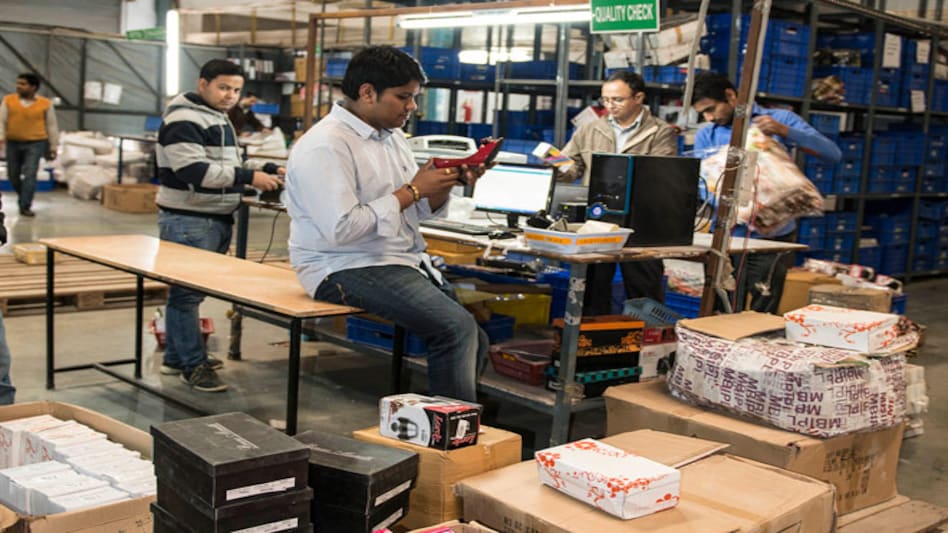 Employees packing and labelling, ready to ship out at Delivery Logistics. Employees packing and labelling, ready to ship out at Delivery Logistics.