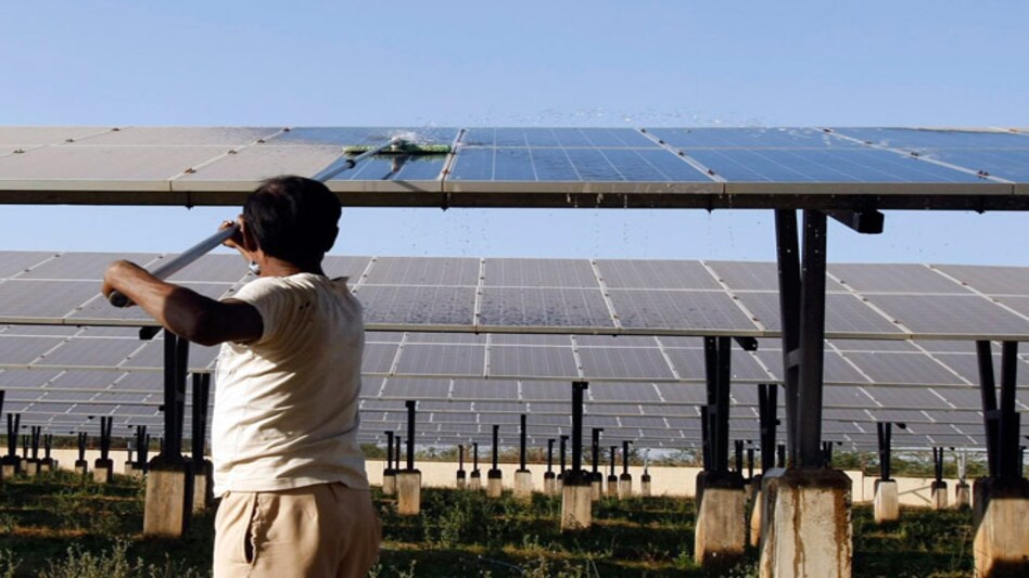 A worker cleans photovoltaic solar panels inside a solar power plant at Raisan village near Gandhinagar, Gujarat. PHOTO: Reuters A worker cleans photovoltaic solar panels inside a solar power plant at Raisan village near Gandhinagar, Gujarat. PHOTO: Reuters