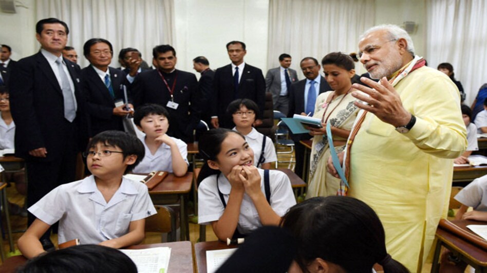Prime Minister Narendra Modi interacts with students during a visit to Taimei Elementary school in Tokyo on Monday. PTI Photo Prime Minister Narendra Modi interacts with students during a visit to Taimei Elementary school in Tokyo on Monday. PTI Photo