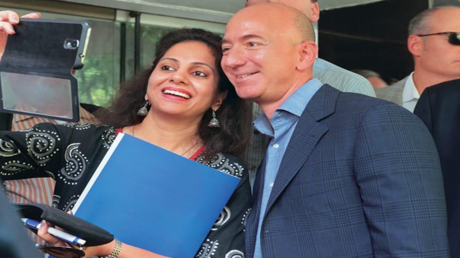 A woman takes a selfie with Amazon.com CEO Jeff Bezos following an event in New Delhi. A woman takes a selfie with Amazon.com CEO Jeff Bezos following an event in New Delhi.