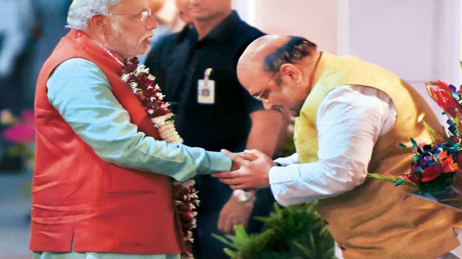 Prime Minister Narendra Modi is felicitated by BJP president Amit Shah in New Delhi on Oct 19, 2014