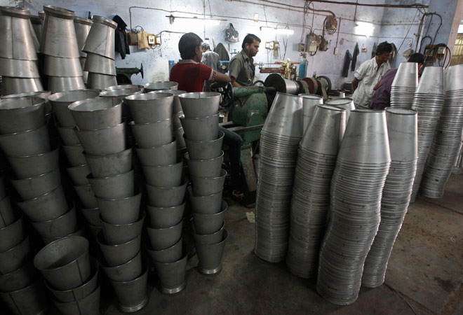 Employees work inside a steel bucket manufacturing unit at an industrial area on the outskirts of Ahmedabad on January 2, 2014. (Photo: Reuters) Employees work inside a steel bucket manufacturing unit at an industrial area on the outskirts of Ahmedabad on January 2, 2014. (Photo: Reuters)