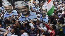 Delhi election results: Aam Aadmi Party crushes BJP, big blow for PM Narendra Modi Supporters of AAP hold portraits of the party's chief Arvind Kejriwal during the celebrations outside the party office in New Delhi. (Photo: Reuters)