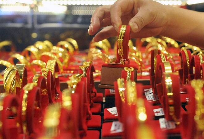 Gold sheds Rs 90 to Rs 25,600 on muted demand; silver ends flat