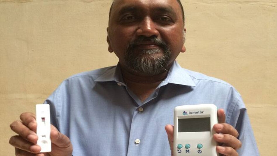 DiabetOmics co-founder, president and CEO Srinivasa Nagella with the saliva-based testing strip and reader. DiabetOmics co-founder, president and CEO Srinivasa Nagella with the saliva-based testing strip and reader.