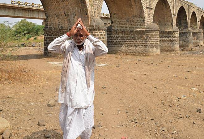 An old man praying on the dry bed of the Sindphana river (Photographs by: Milind Shelte) An old man praying on the dry bed of the Sindphana river (Photographs by: Milind Shelte)