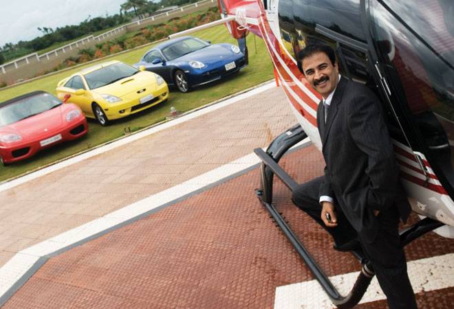 SANJAY GHODAWAT with his Eurocopter chopper and three of the 100-plus luxury cars that he owns (Photo: Outlook Business) SANJAY GHODAWAT with his Eurocopter chopper and three of the 100-plus luxury cars that he owns (Photo: Outlook Business)