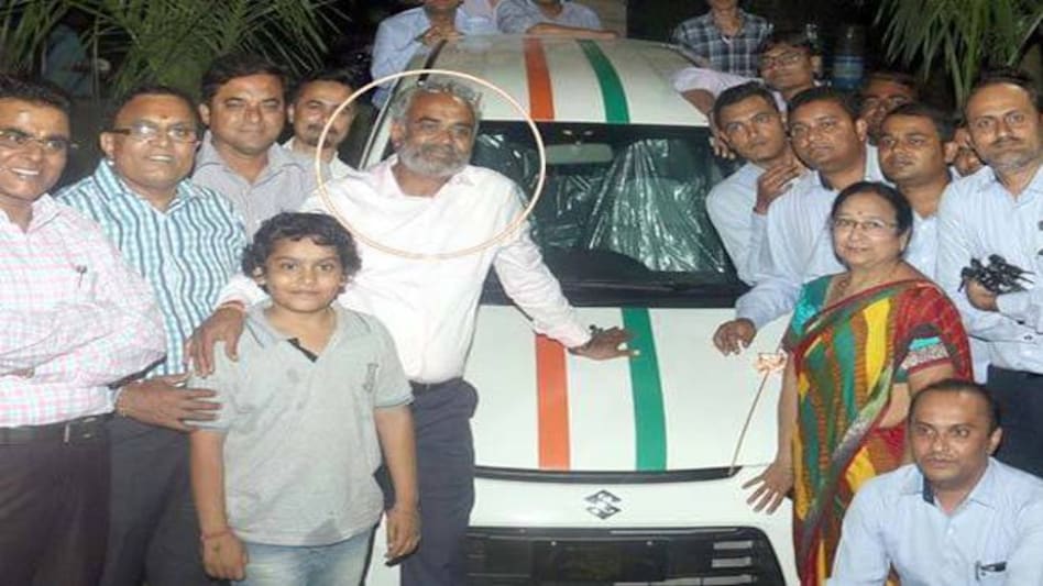 Surat-based businessman Savji Dholakia with his employees. Surat-based businessman Savji Dholakia with his employees.
