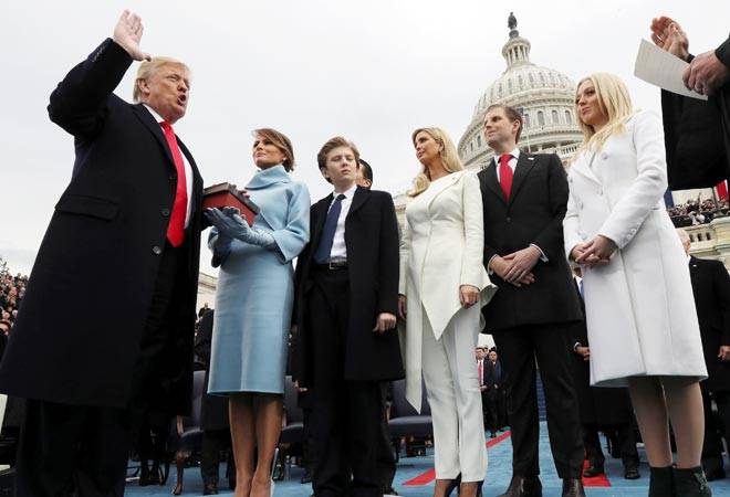 Dollar slips after Trump's protectionist address, Asia shares resilient