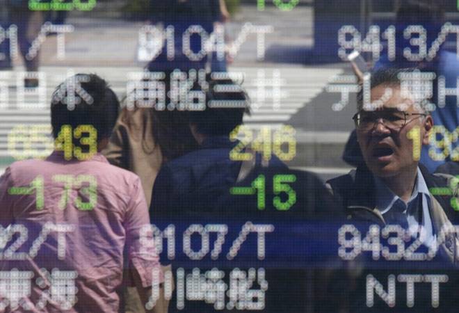 Asia stocks mixed, dollar steady on data, but Trump's troubles weigh