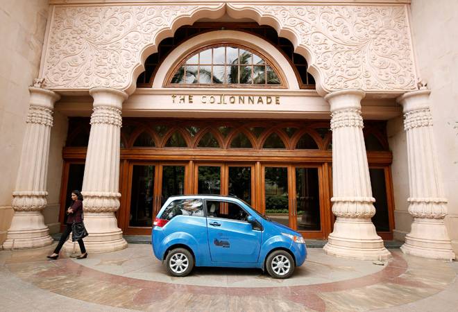 A woman walks past a Mahindra e2o electric car during a media preview in Bengaluru. (Photo: Reuters) A woman walks past a Mahindra e2o electric car during a media preview in Bengaluru. (Photo: Reuters)