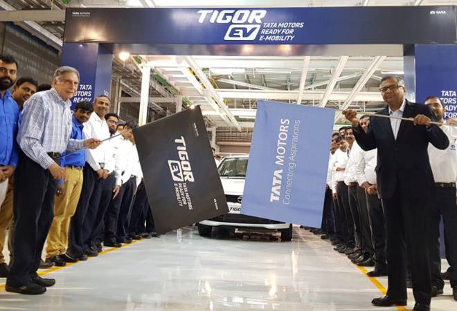 Ratan Tata and N Chandrasekaran flagged off the first batch of Tata Tigor EVs from Sanand facility. Image: Twitter Ratan Tata and N Chandrasekaran flagged off the first batch of Tata Tigor EVs from Sanand facility. Image: Twitter