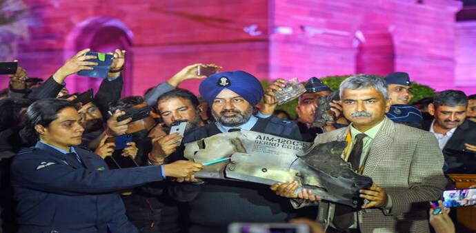 India-Pakistan tension: IAF officers show the debris of AIM-120C AMRAAM missile after the press beifing by Indian Air Force, Army and Navy where this was presented as evidence to Pakistan's use of F-16 jets in yesterday's raids. Photo credit: PTI India-Pakistan tension: IAF officers show the debris of AIM-120C AMRAAM missile after the press beifing by Indian Air Force, Army and Navy where this was presented as evidence to Pakistan's use of F-16 jets in yesterday's raids. Photo credit: PTI