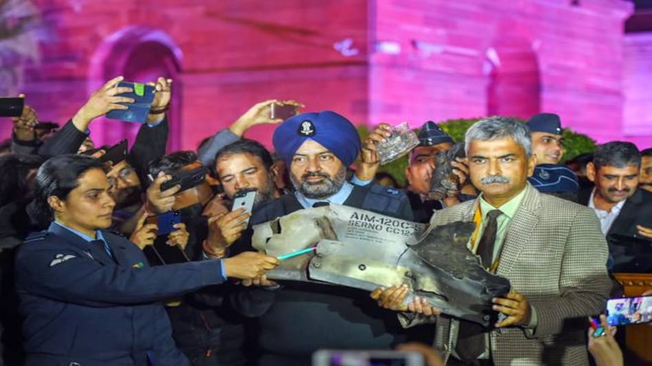 India-Pakistan tension: IAF officers show the debris of AIM-120C AMRAAM missile after the press beifing by Indian Air Force, Army and Navy where this was presented as evidence to Pakistan's use of F-16 jets in yesterday's raids. Photo credit: PTI India-Pakistan tension: IAF officers show the debris of AIM-120C AMRAAM missile after the press beifing by Indian Air Force, Army and Navy where this was presented as evidence to Pakistan's use of F-16 jets in yesterday's raids. Photo credit: PTI