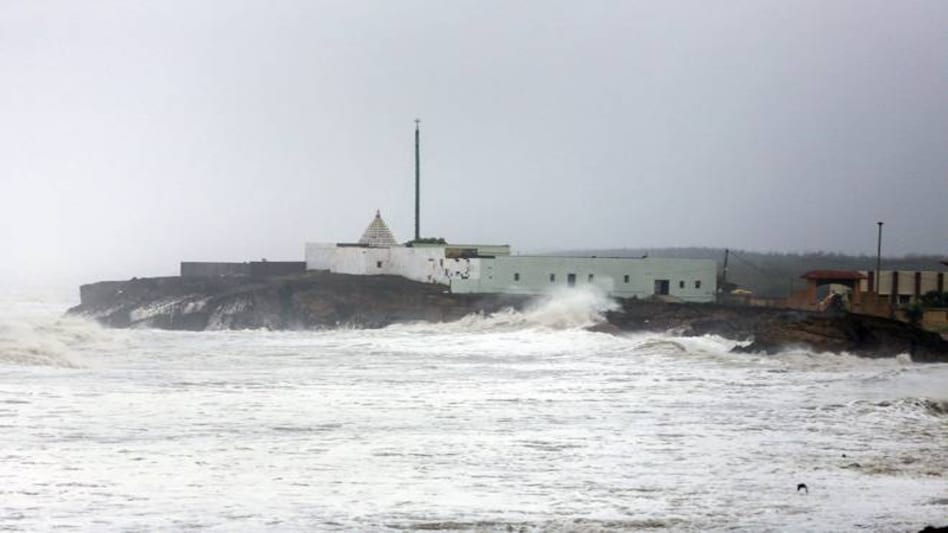 A huge wave hits the wall of a temple along the sea shore during high tide, at Veraval, in Gir Somnath. (Photo: PTI) A huge wave hits the wall of a temple along the sea shore during high tide, at Veraval, in Gir Somnath. (Photo: PTI)