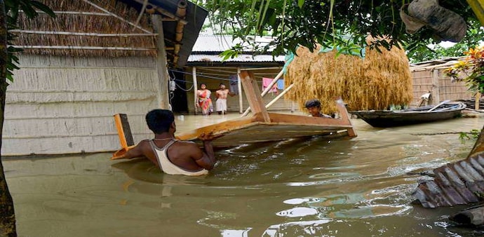 Assam flood: Flood affected villagers shift to safer places from a flooded village of Morigaon district of Assam. Assam flood: Flood affected villagers shift to safer places from a flooded village of Morigaon district of Assam.