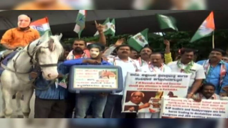 Congress workers Monday brought a horse to protest outside the Sofitel Hotel in Mumbai to signify the alleged horse trading happening in Karnataka. Congress workers Monday brought a horse to protest outside the Sofitel Hotel in Mumbai to signify the alleged horse trading happening in Karnataka.
