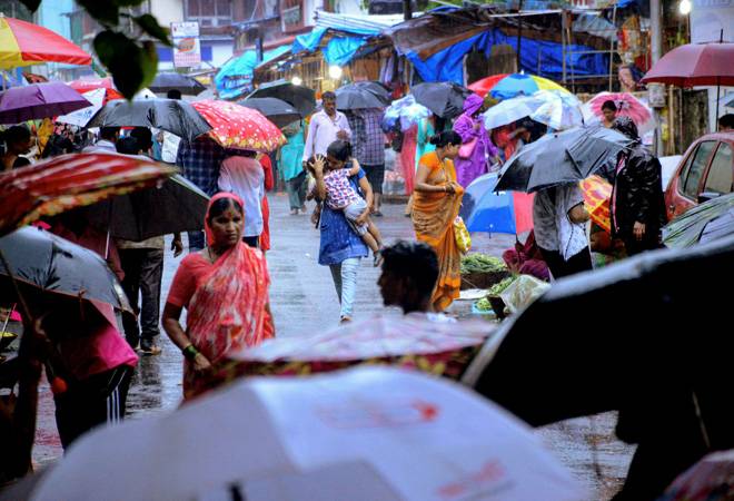 Mumbai rains: People seek shelter during a sudden monsoon rainfall, in Navi Mumbai. (Photo: PTI) Mumbai rains: People seek shelter during a sudden monsoon rainfall, in Navi Mumbai. (Photo: PTI)