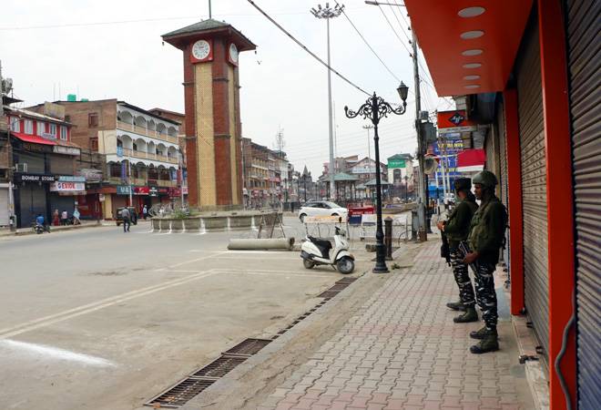 Security personnel stand guard at Lal Chowk in Srinagar as shops remain closed. (Flie photo: IANS) Security personnel stand guard at Lal Chowk in Srinagar as shops remain closed. (Flie photo: IANS)