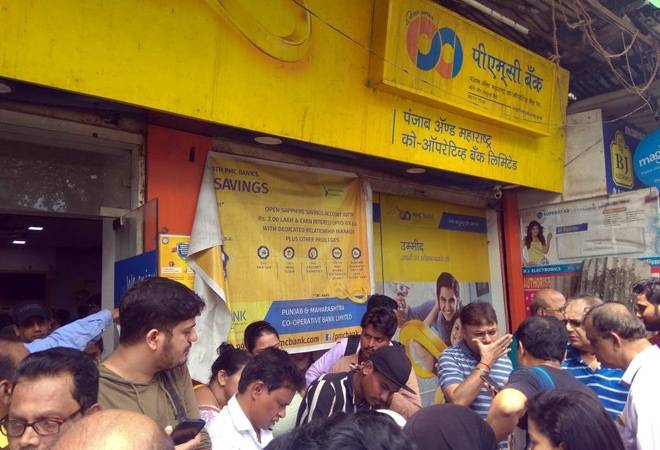 PMC Bank: Customers gather outside on of the bank's branches PMC Bank: Customers gather outside on of the bank's branches